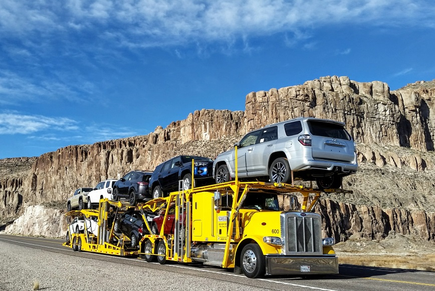 Driving a loaded truck past a rocky cliff